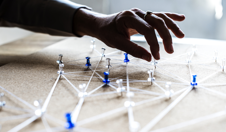 creating-business-connections-concept-strings-thumbtacks-on-a-board