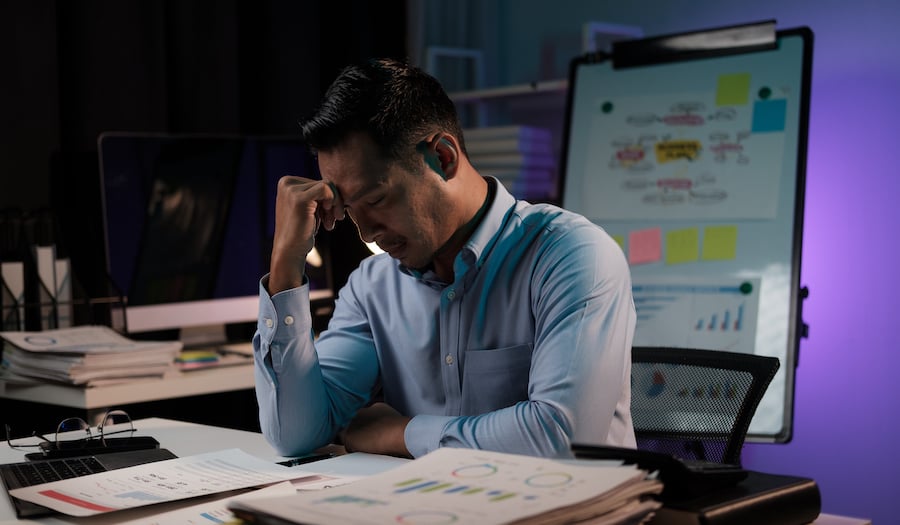 tired-and-frustrated-man-looking-at-financial-reports