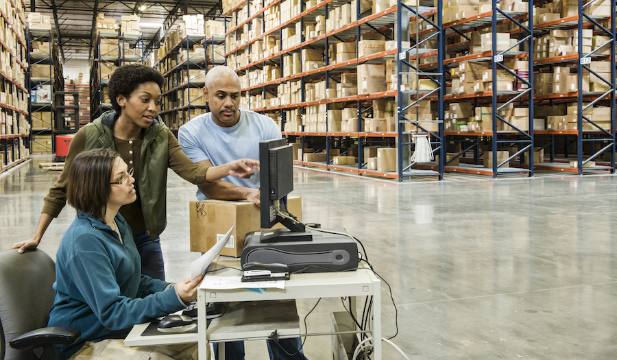 warehouse-workers-checking-inventory-on-a-computer